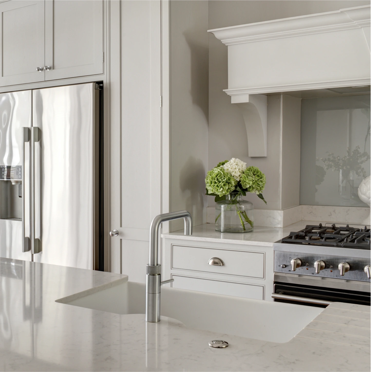 Handcrafted pale cabinetry and stone worktop