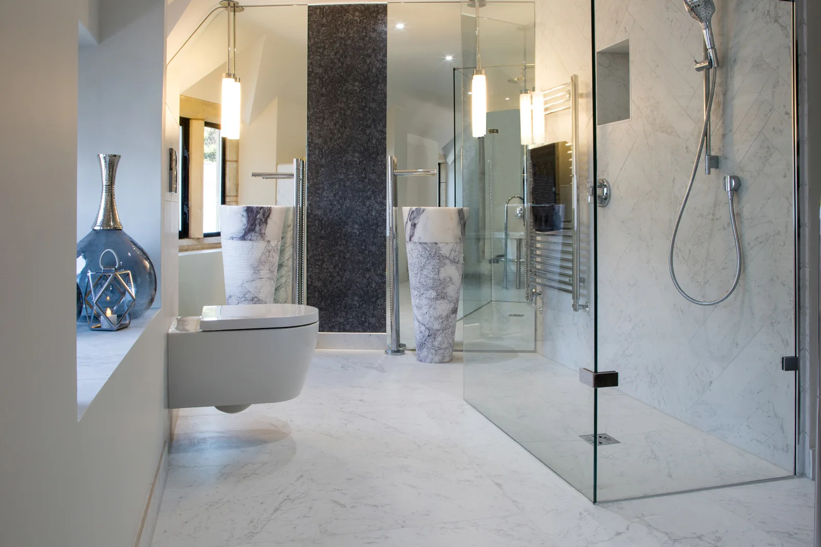 Light marble-look en-suite with a glass walk-in shower and mirrored basin area