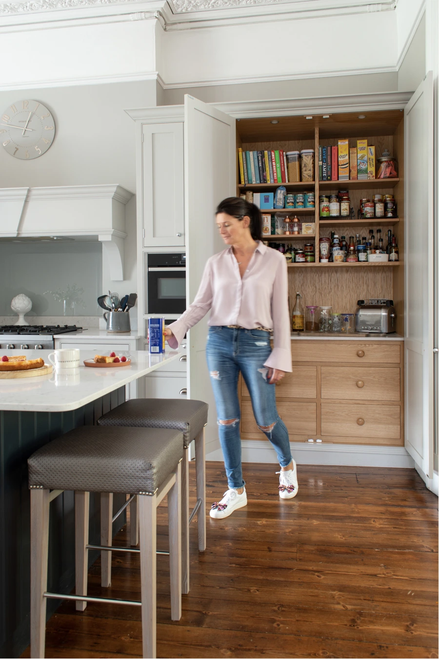 Alison beside the island and open pantry in her handmade kitchen